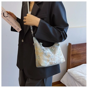 Close-up of blue floral brocade jacquard texture on vintage style shoulder bag