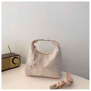 Detailed close-up of a vintage Chinese style hobo bag with pink floral jacquard landscape