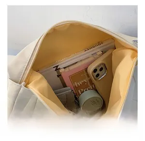 Interior view of soft white shoulder bag showing large capacity with yellow lining