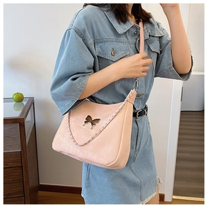 Minimalist light pink crescent shoulder bag with butterfly logo and silver metal chain