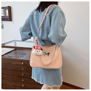 Pink PU shoulder bag detail with silver butterfly buckle and white plush puppy charm