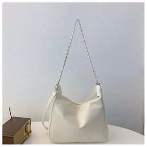 Detailed view of white hobo bag with silver chain strap and extra leather shoulder strap
