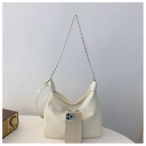 Cream crescent moon bag with butterfly buckle and chain strap showing internal storage