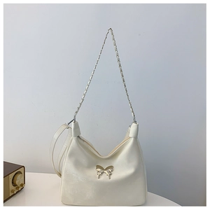 Detail of hobo bag with silver butterfly buckle and metallic chain strap in cream white