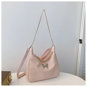 Detail of light pink shoulder bag with silver butterfly buckle and dual straps