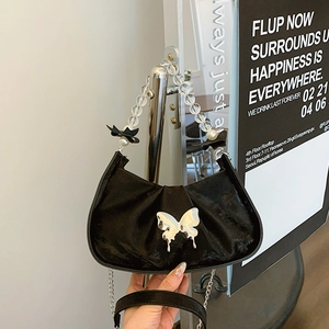 Black velvet underarm bag featuring silver butterfly buckle and clear beaded chain strap