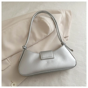 Detail of silver baguette underarm bag with double thin straps and knot details