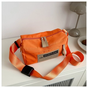 Close-up of vibrant orange oxford sports crossbody bag with adjustable buckle strap