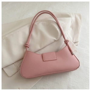 Detail of pink leather underarm bag with knot strap accents and silver metal end caps