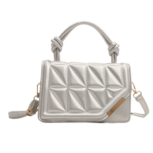 Silver geometric quilted crossbody bag with a knotted top handle and golden hardware