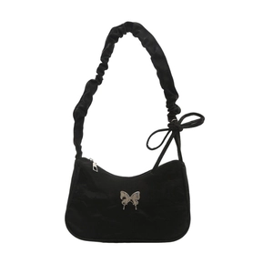 Black hobo shoulder bag with pleated strap and silver butterfly accent in Y2K style