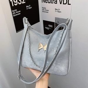 Sliver-grey minimalist tote bag with metal butterfly charm and long shoulder strap