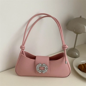 Pink faux leather baguette underarm bag with sparkling crystal buckle on white background