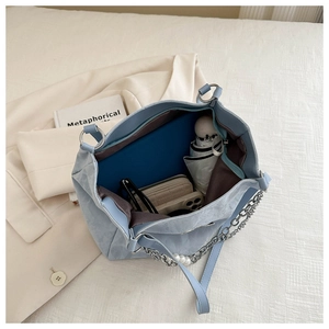 Internal view of a light blue tote bag showing its large capacity for daily essentials