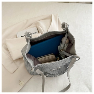 Detail view of large capacity silver tote bag interior showing ample storage for daily essentials