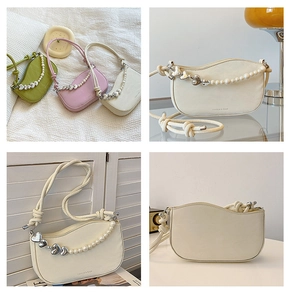 Detail of half-moon bag featuring pearl heart chain and rope shoulder strap