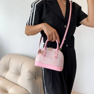 Pink shell crossbody bag in woven fabric with leather trim and gold zippers for women