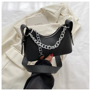 Close-up of black PU leather crescent bag featuring silver chain link and wide strap