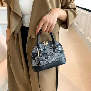 Detail of vintage dome shell bag with Toile de Jouy patterns and gold hardware