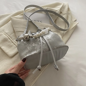 Silver bucket bag with metallic cracked texture and decorative pearl handle accents