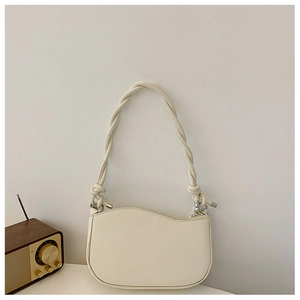 Detail of cream white shoulder bag with wavy top flap and thick twisted rope strap