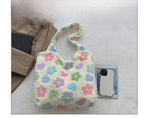 Flat lay showing the capacity of a plush floral tote bag with a tablet and smartphone