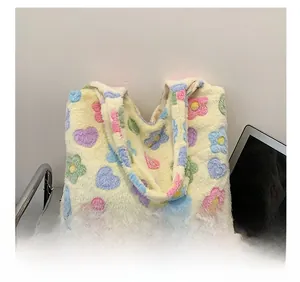 Close-up of soft plush tote bag featuring colorful heart and floral pop-art prints