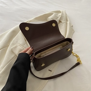 Dark brown faux leather crossbody bag with gold chain strap and magnetic flap closure