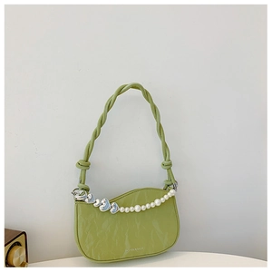Detail of avocado green shoulder bag featuring pearl heart chain and pleated texture