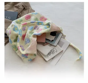 Macro shot of large plush tote bag showing storage for tablet, phone and wallet