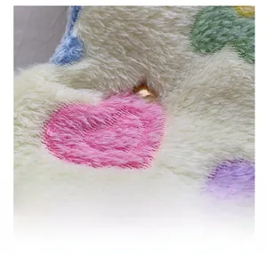 Close-up detail of soft plush tote bag fabric with colorful heart pattern texture
