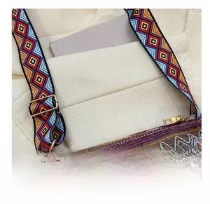 Detail of bohemian woven tote bag with colorful zigzag texture and adjustable strap