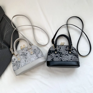 Detailed top view of embroidered shell handbags with sleek golden hardware and straps