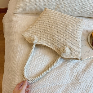 Minimalist straw tote bag with cotton rope handles for summer beach vacations