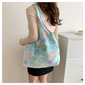Detail of soft plush tote bag with colorful flower patterns on mint green faux fur