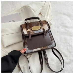 Detail of a mini retro color-block backpack in brown wool and PU leather textures
