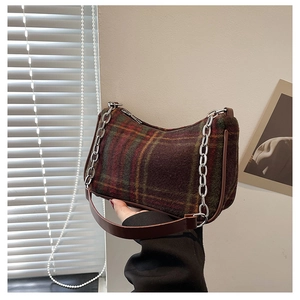 Detail of hobo bag with vintage plaid wool fabric and silver chain shoulder strap