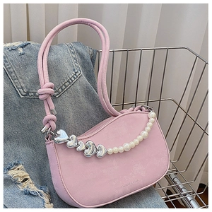 Pink shoulder bag detail showing silver heart charms, pearls and FASHION & BAGS logo