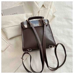 Top view of two-tone PU leather mini backpack with contrast fabric flap and metal hardware