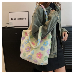 Detail of plush tote bag with colorful 3D flower patterns and soft fluffy texture