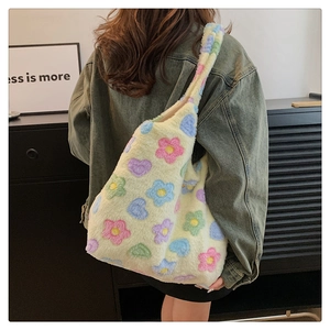 Detailed side view of a large fluffy tote bag featuring colorful flower and heart patterns