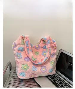 Detail of soft pink plush tote bag featuring colorful heart and floral patterns