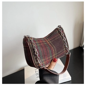 Detailed close-up of vintage plaid hobo bag with woolen fabric texture and silver chain