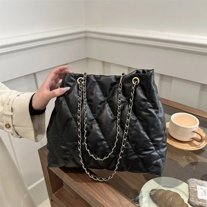 Chic black quilted tote bag with gold chain strap in a classic rhombus pattern design