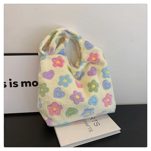 Close-up of soft plush tote bag with colorful floral and heart patterns for women