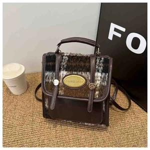 Detail of vintage contrast plaid and brown PU leather mini backpack with gold metal plaque