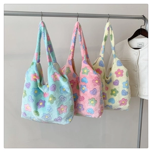 Detailed plush texture of colorful floral tote bags in blue, pink, and beige pastel shades
