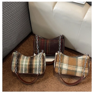 Close-up of wool plaid baguette bags in three retro colors with chain straps
