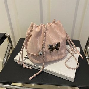 Sac seau rose pâle à texture marbrée avec papillon argenté et bandoulière chaîne
