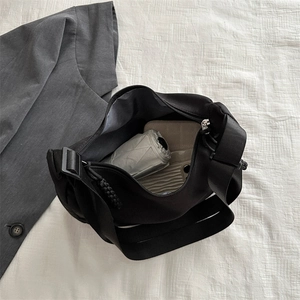 Large black nylon tote bag showing spacious interior with an umbrella and wallet